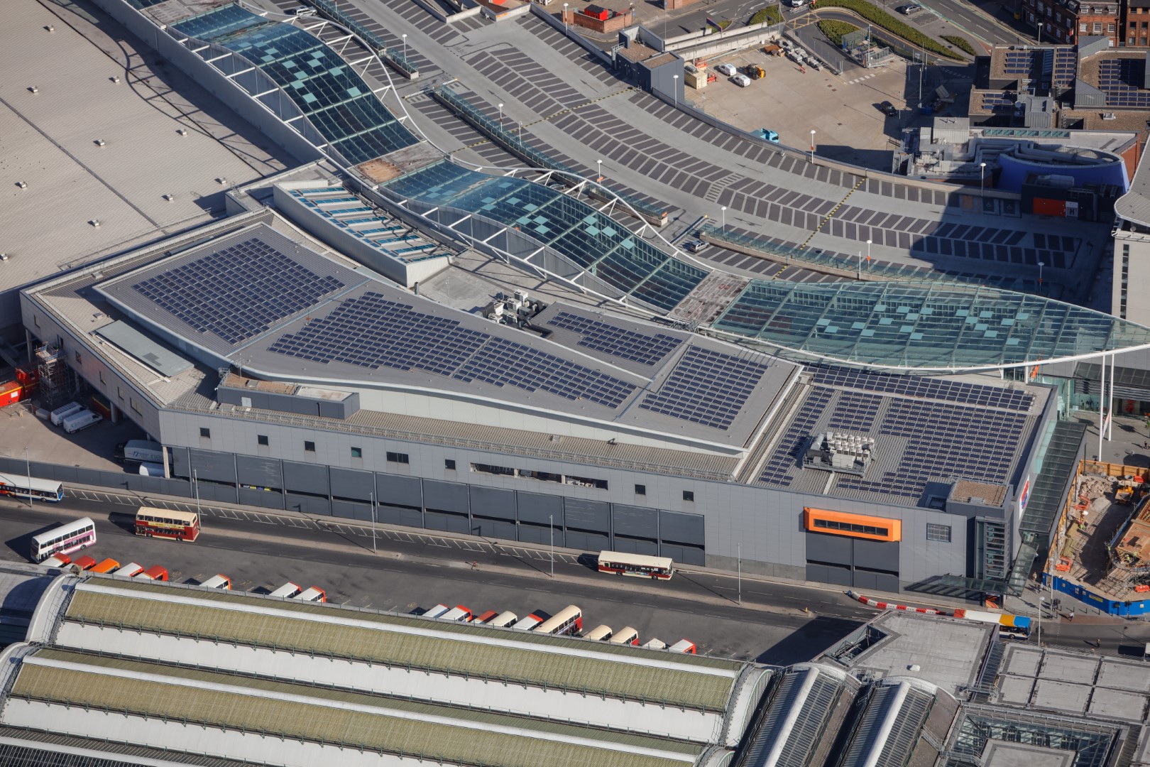 birds eye view of solar panels on shopping centre roof