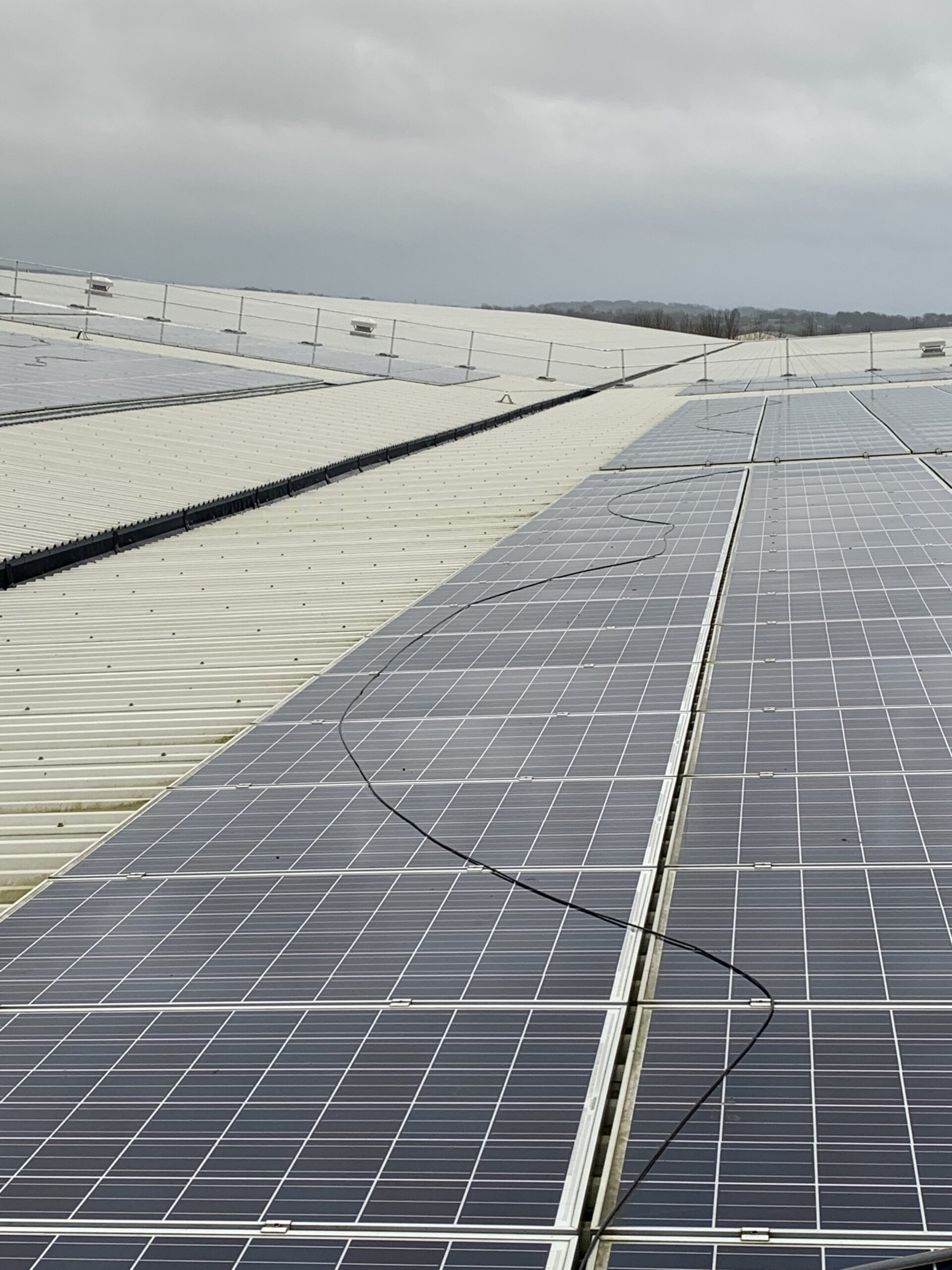 black cable resting on solar panels